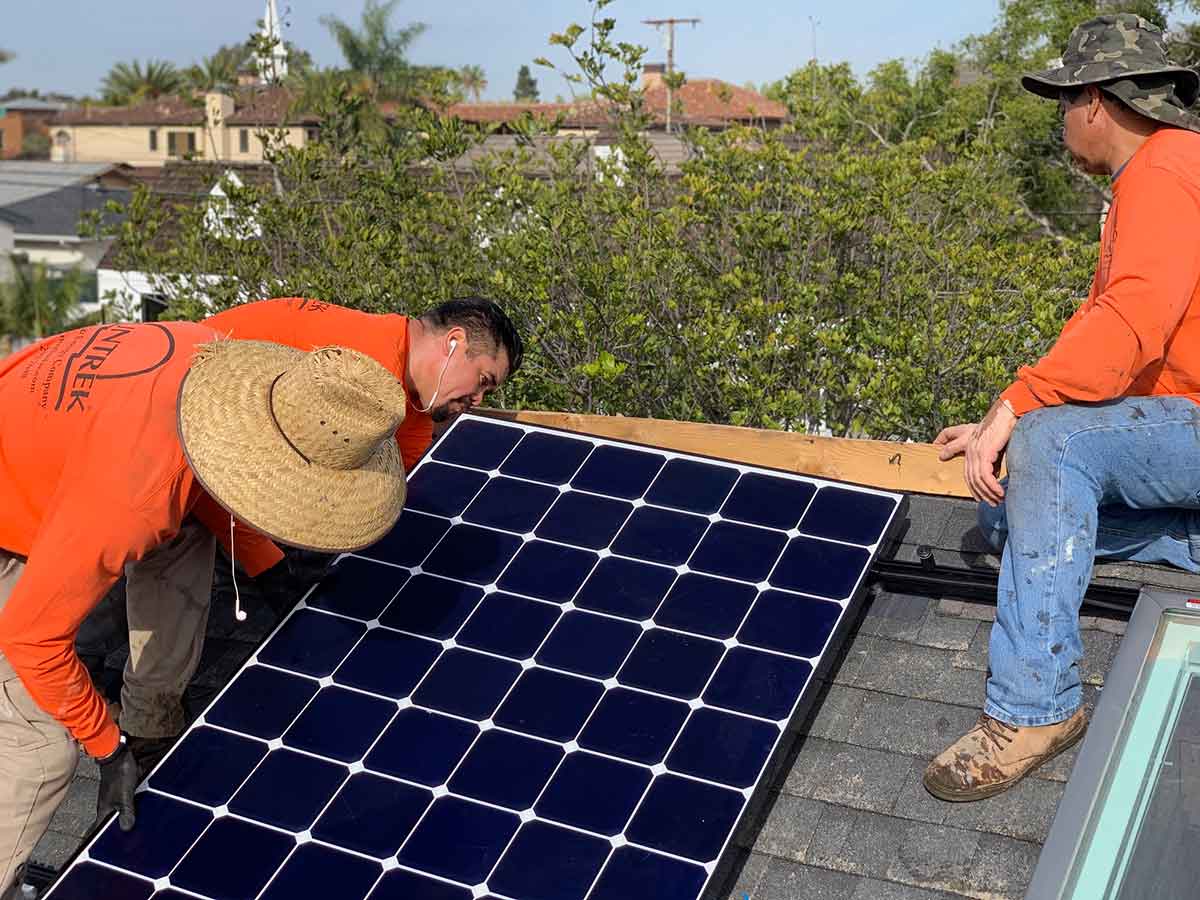 Suntrek professionals working on rooftop solar panel installation at a residential home