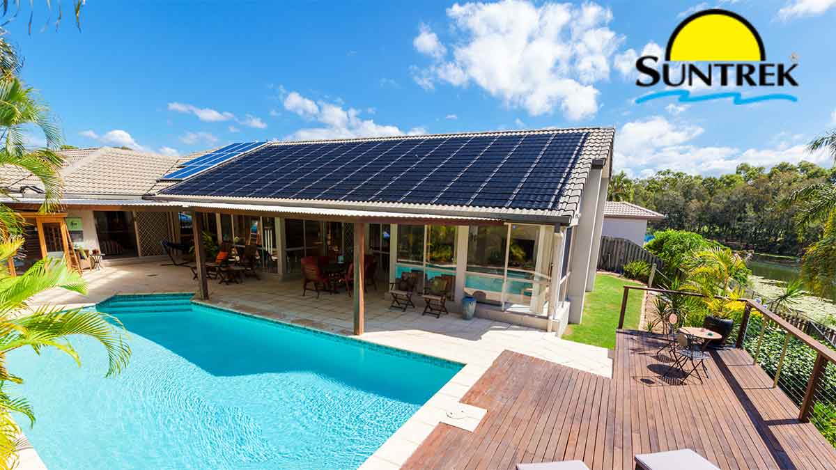 Residential house with rooftop solar panels and a backyard pool
