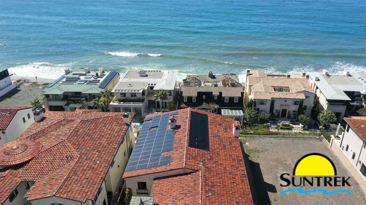 House near the ocean with solar panels installed on the roof