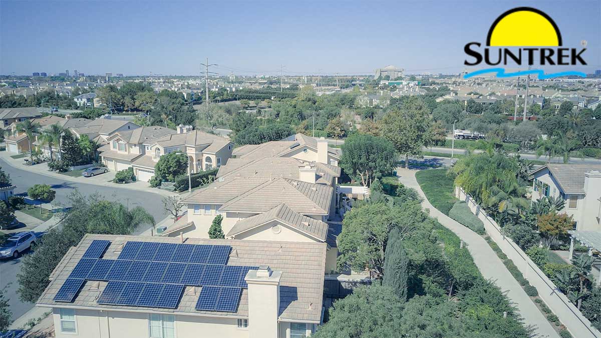 Aerial view of a residential community with multiple homes with rooftop solar panels