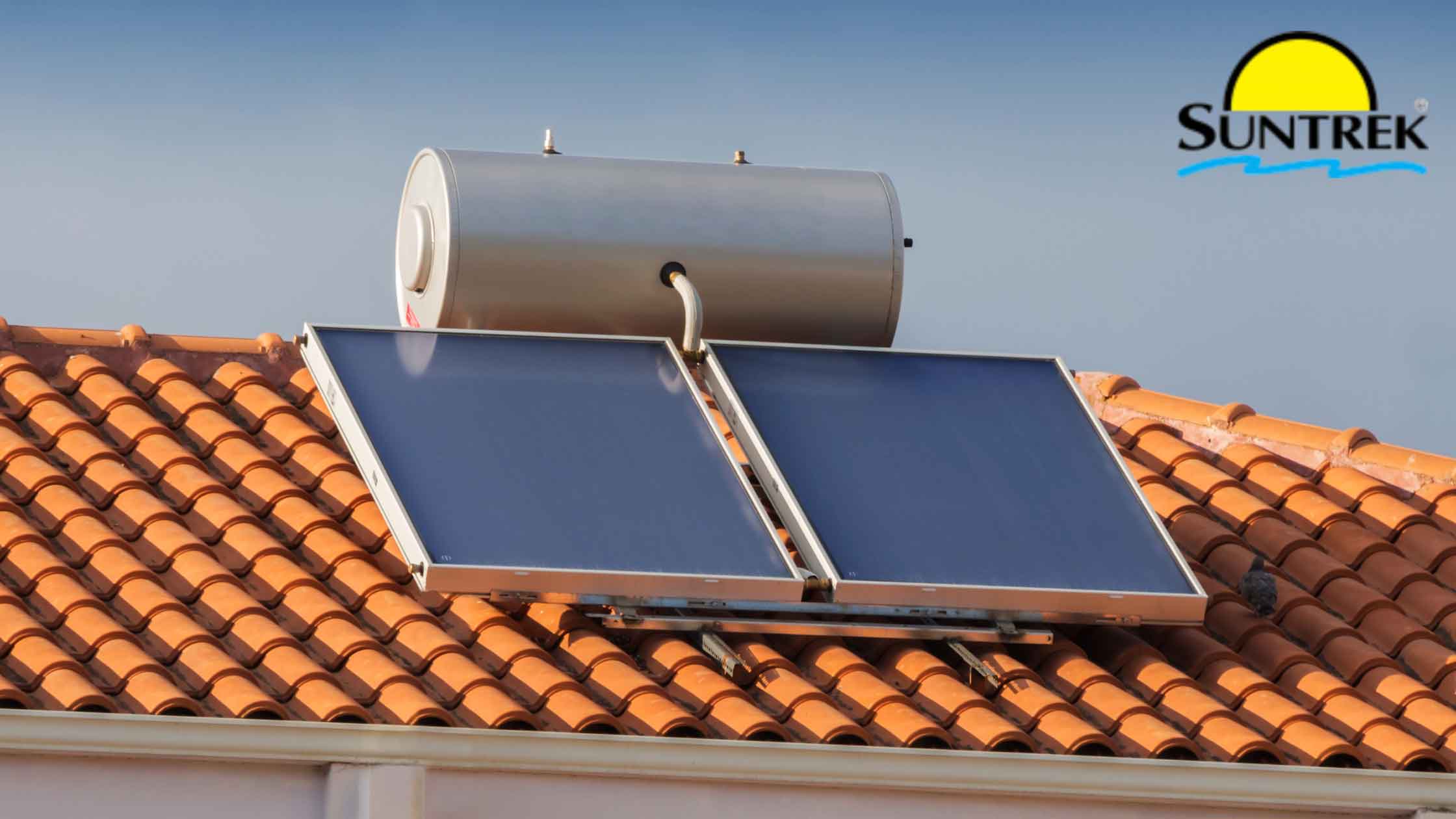 Rooftop view showing solar panels installed beside a water tank
