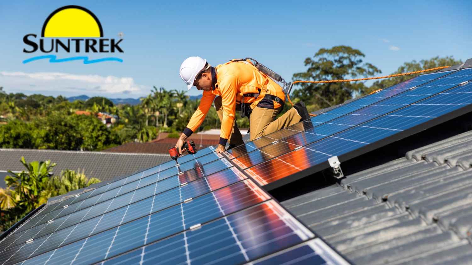 Worker on rooftop adjusting solar panels