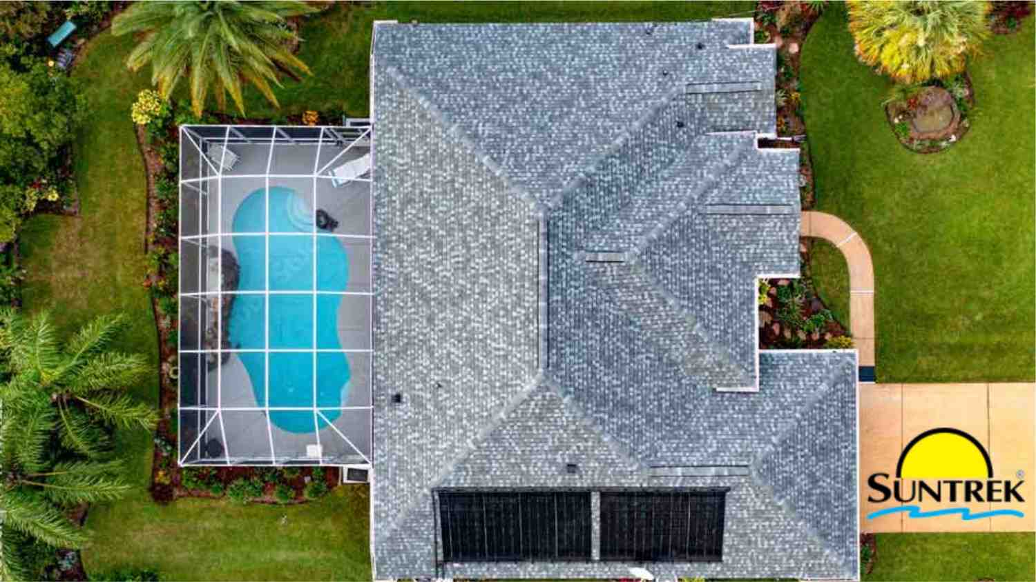 A residential home with a backyard pool powered by solar panels