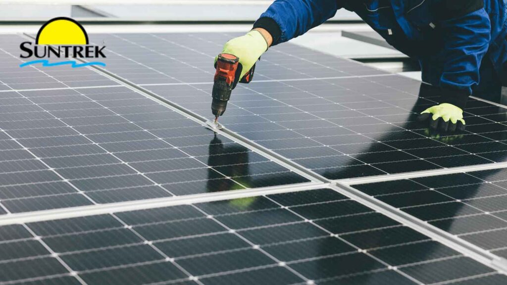 Technician working on solar panels on a rooftop.