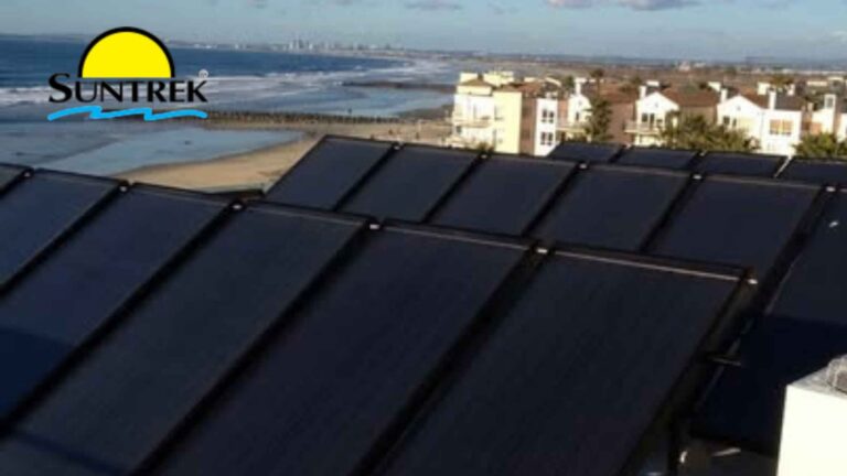Residential roof with a solar water heating system and collector panels installed.