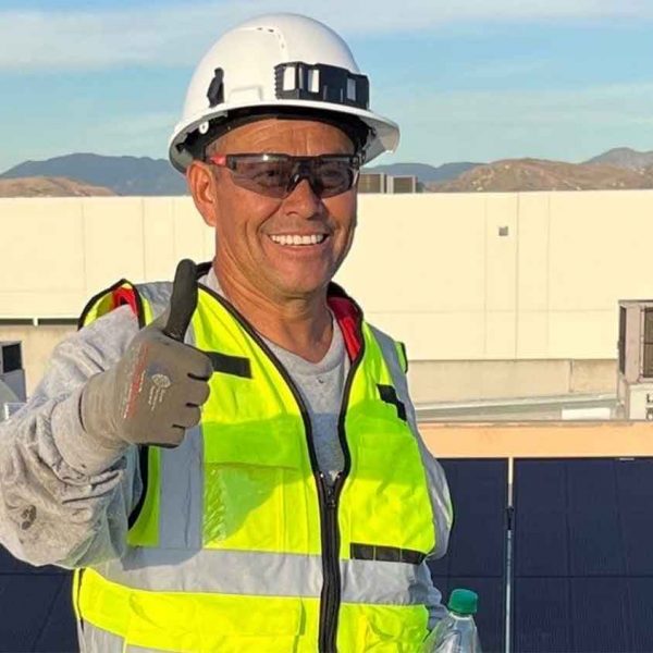 Suntrek technician on a client’s property installing solar panels on the roof