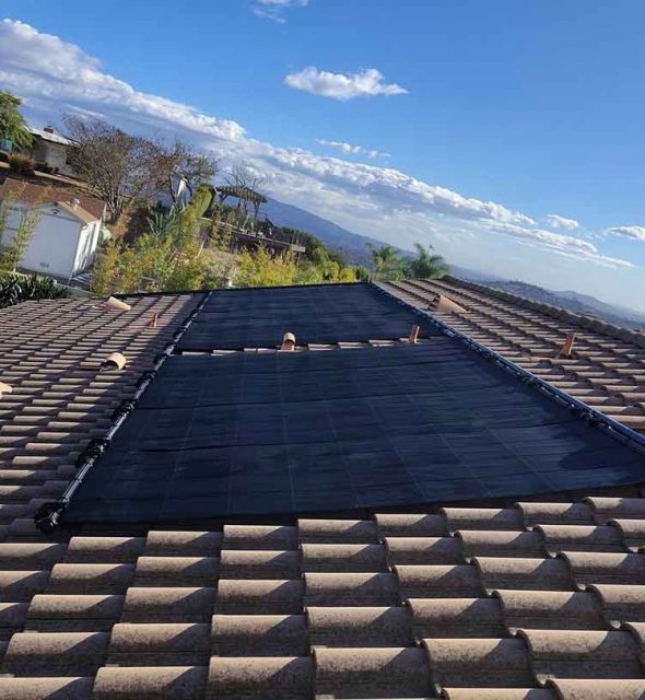 Clean solar panels mounted on a home’s roof under clear skies.