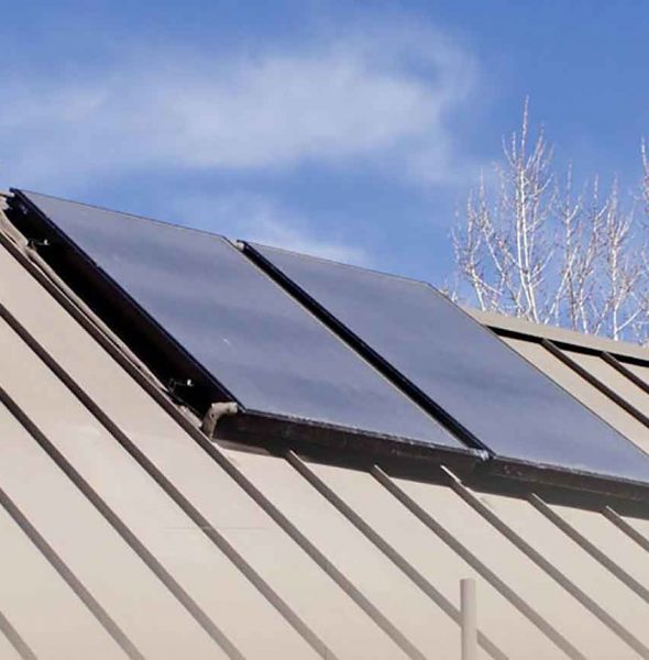Detailed view of two solar panels installed on a home’s roof