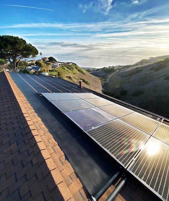 Close-up of a house roof fitted with solar panels, harnessing renewable energy.