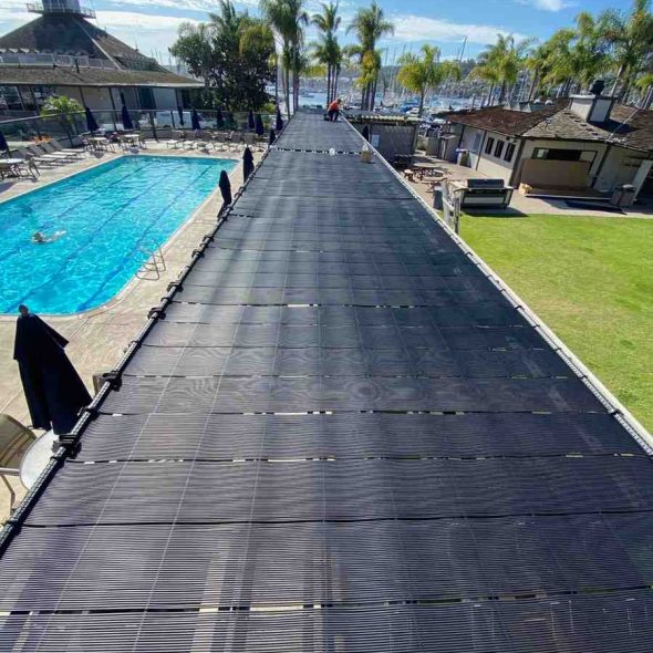 House with a backyard pool powered by rooftop solar panels