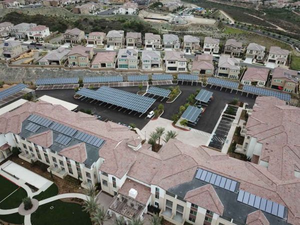 Solar energy system installed on a rooftop of a multi-family residence.