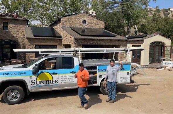 Technicians in front of a Suntrek Solar truck and finishing up a solar panel installation.